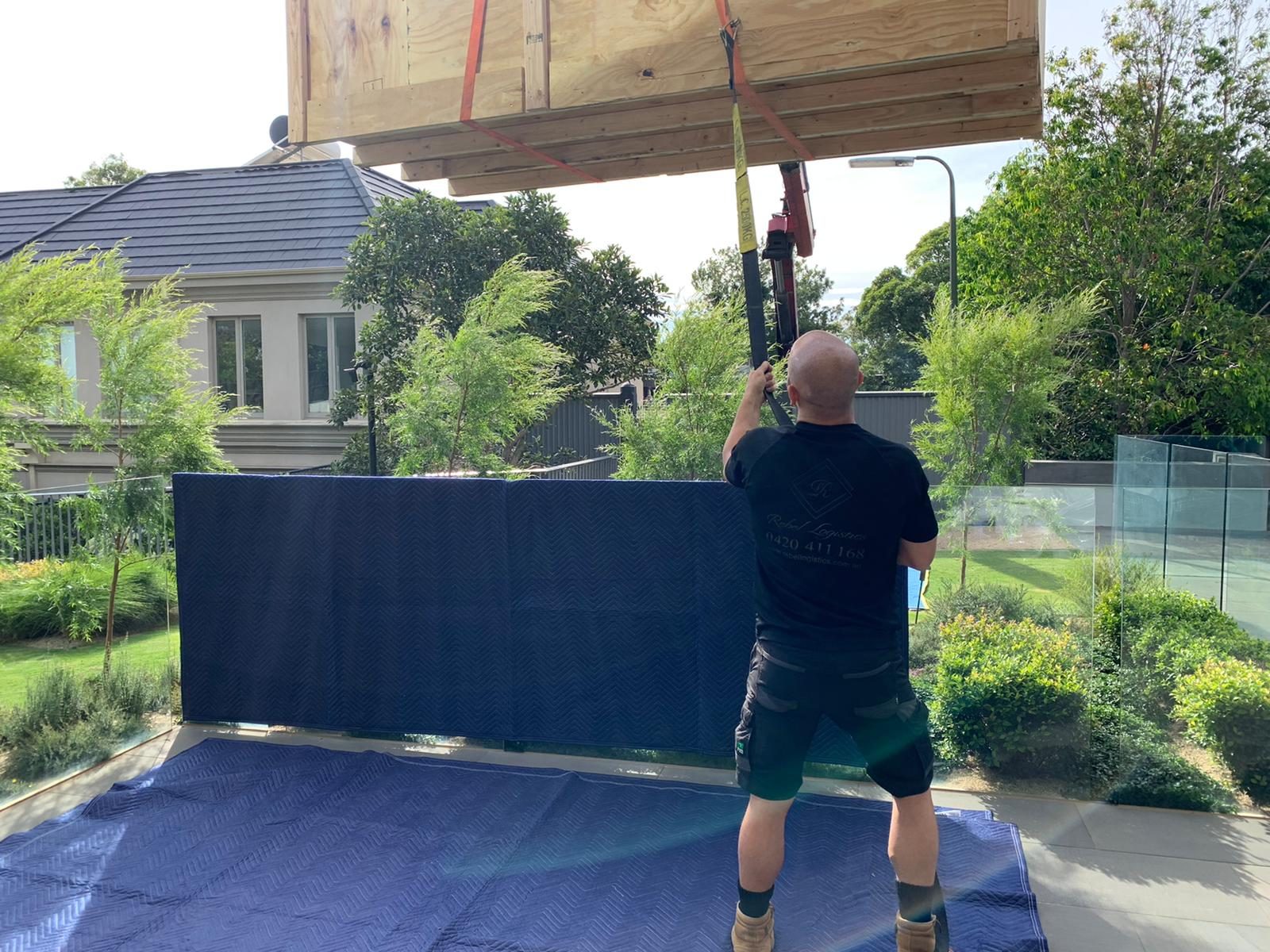 Heavy lift and craning: Clearing the roofline into the rear garden, Melbourne